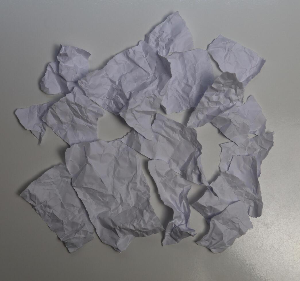 Scraps of paper divided into pieces on a white background. White paper. photo