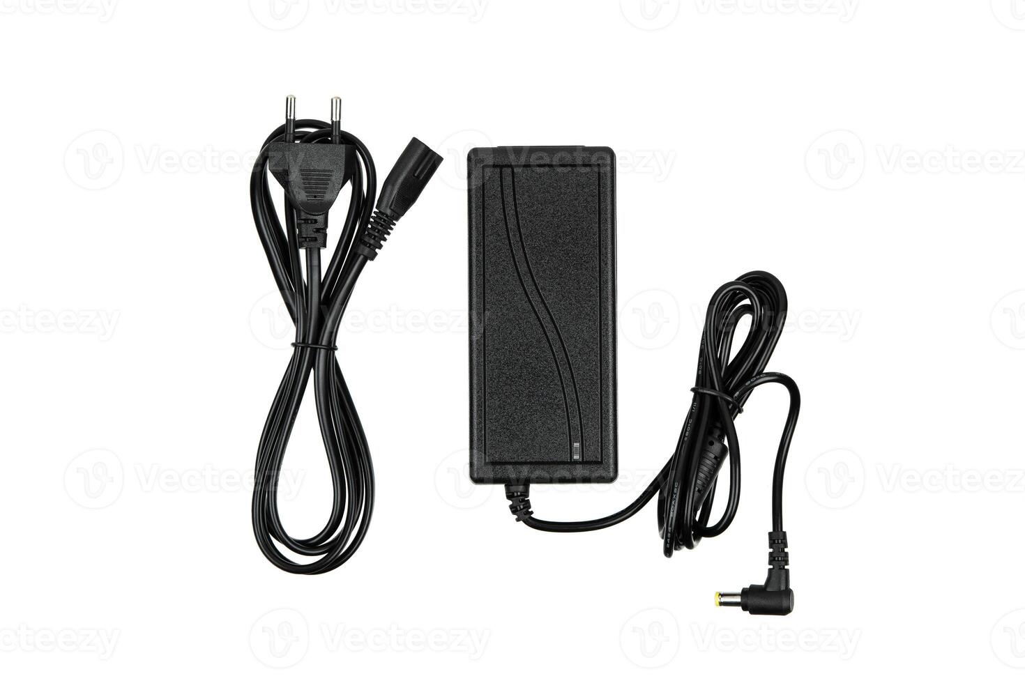 A black power adapter with two cables, one ending in a plug for an outlet and the other in a connector for a device, isolated on a white background. photo