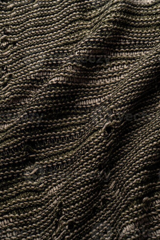 Detailed view of woven fabric showcasing a blend of dark and light threads, forming an intricate texture and ideal for use in textile design. photo