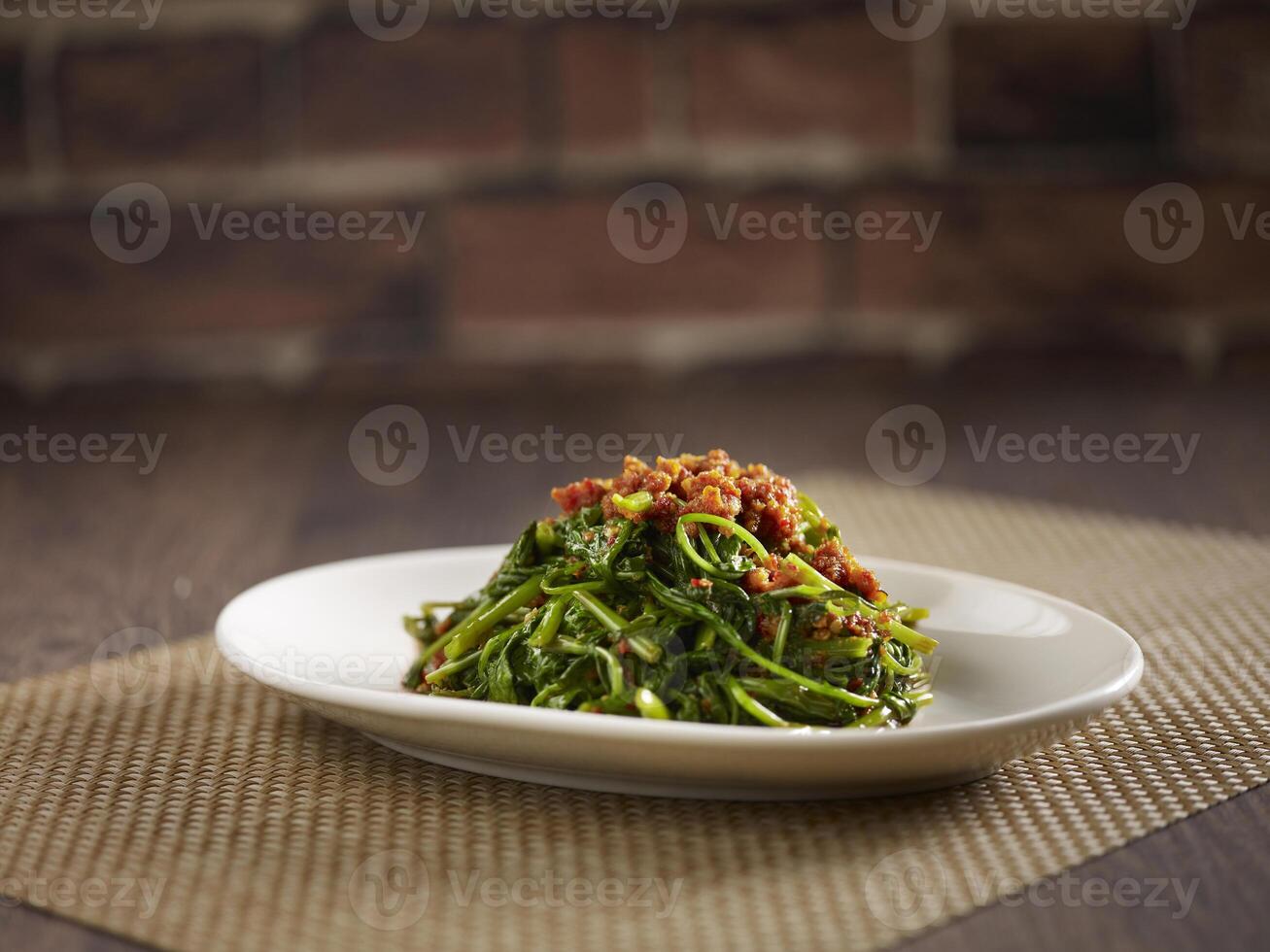Sauteed Kang Kong with Sambal served in a dish isolated on mat side view on dark background photo