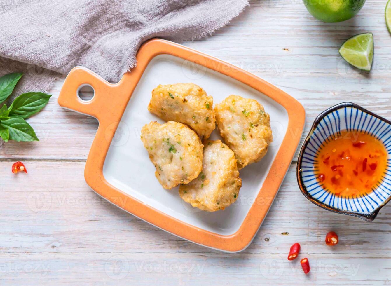 Fried Homemade Shrimp Cake with sweet chili dipping sauce and lemon served in plate isolated on wooden background top view of Hong Kong food photo