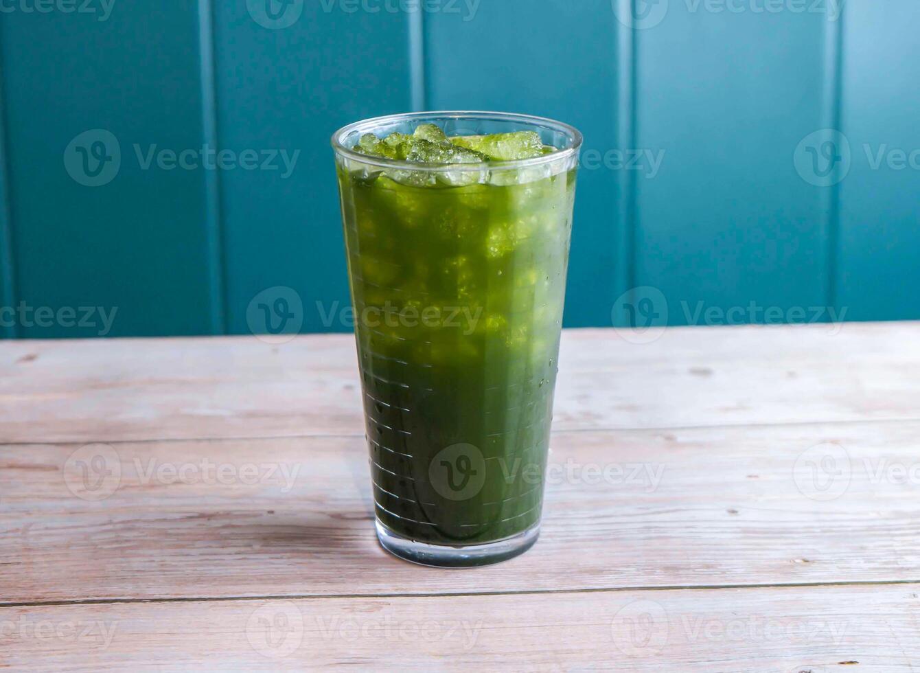 Fresh Coconut with Centella Asiatica ice drink with iced cubes served in glass isolated on wooden background side view of Hong Kong drink photo