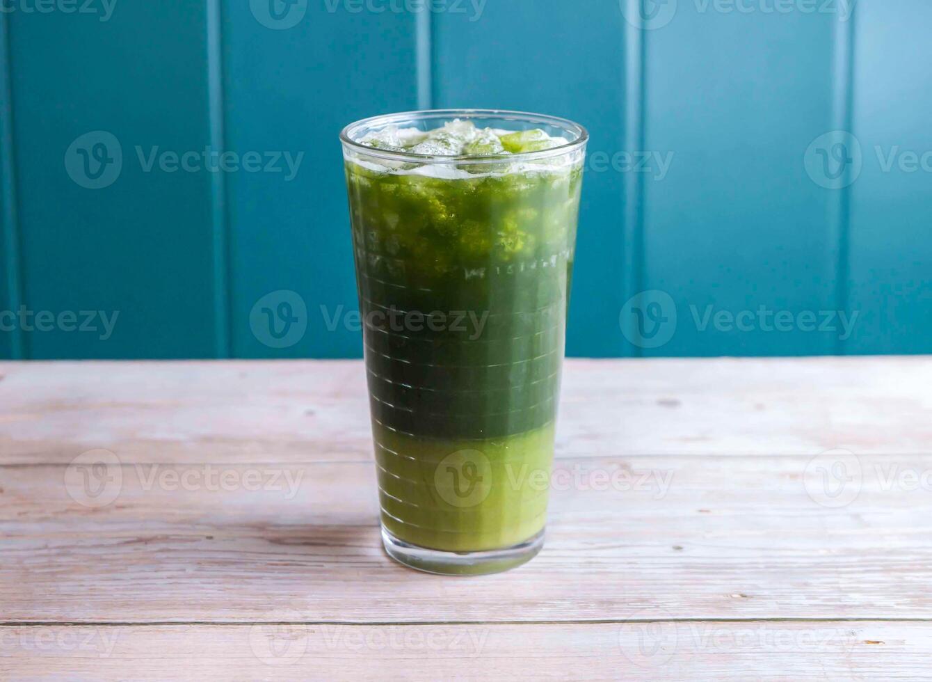 Iced Matcha Lemonade, Ice Mung Bean and Centella Asiatica drink with ice cube served in glass isolated on wooden background side view of Hong Kong drink photo
