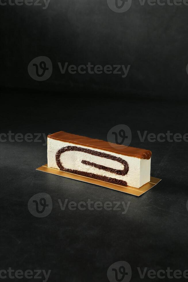 White Chocolate Butterscotch Cake Block isolated on dark background top view of baked item dessert photo
