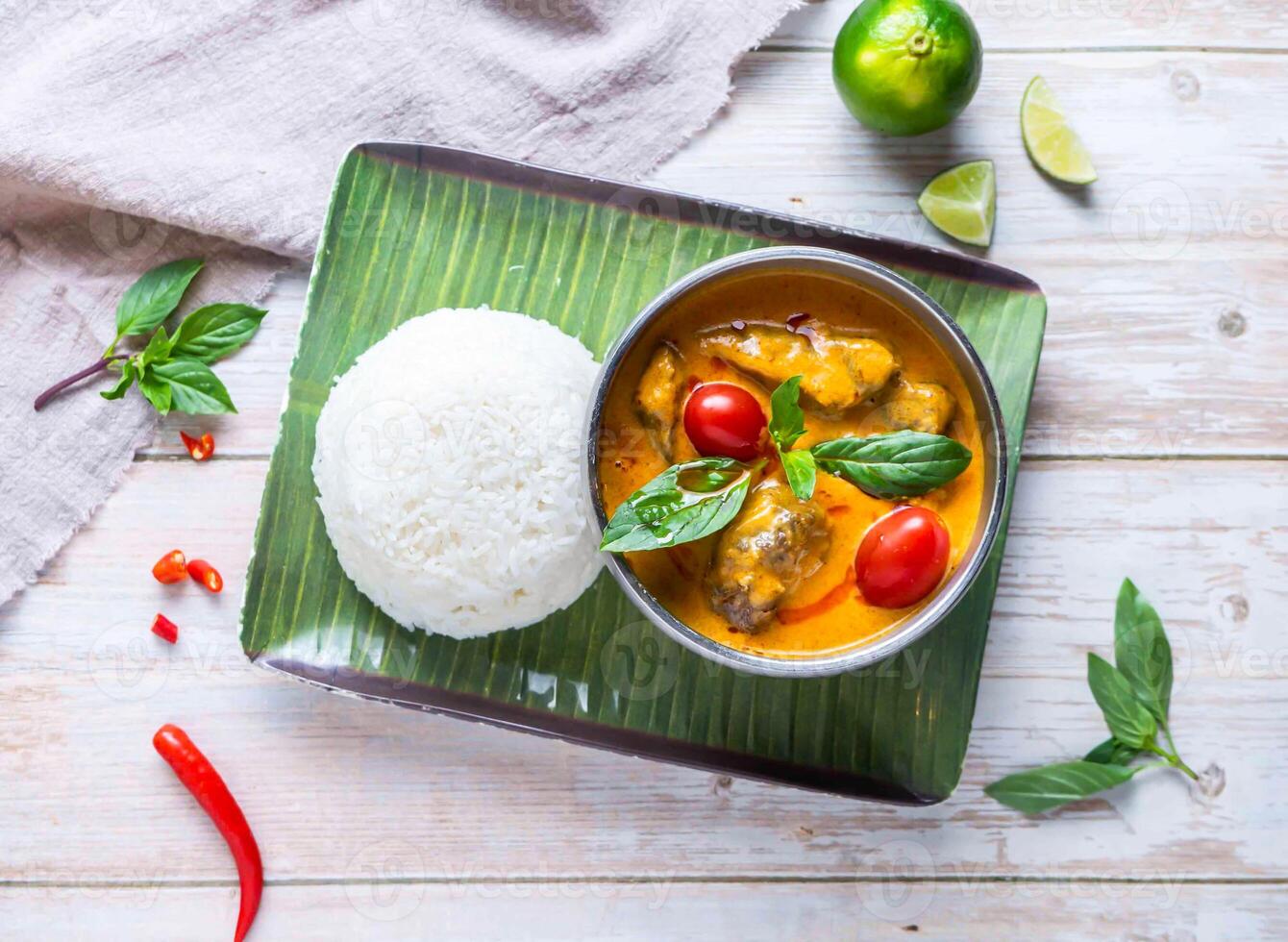 Thai chicken Red Curry with Rice with lemon served in plate isolated on wooden background top view of Hong Kong food photo