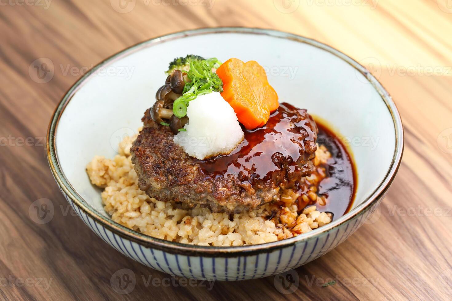 Japanese Hamburg Steak Rice bowl with gravy and vegetables served in bowl isolated on table closeup side view of Japanese food photo