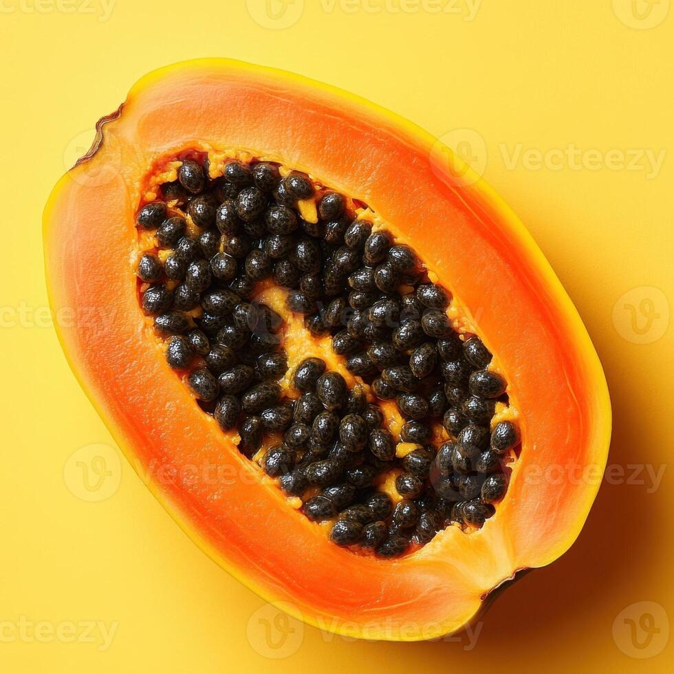 A bright and colorful image of a papaya fruit cut in half, revealing its juicy flesh and seeds, set against a vibrant yellow background. Perfect for health, wellness, and tropical food promotions. photo