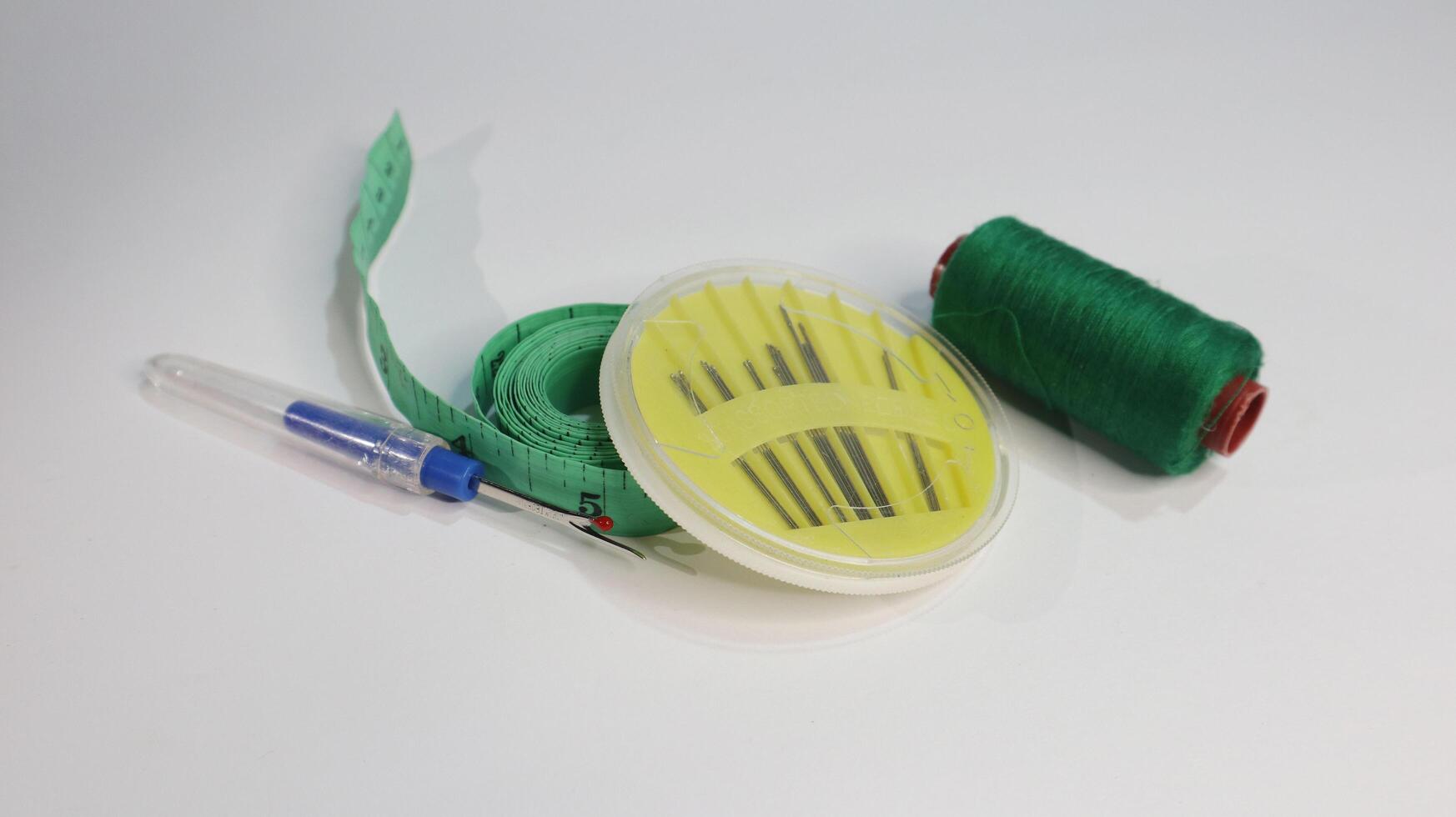 Sewing Tools Set. Thread, Measure Tape, and Needle photo