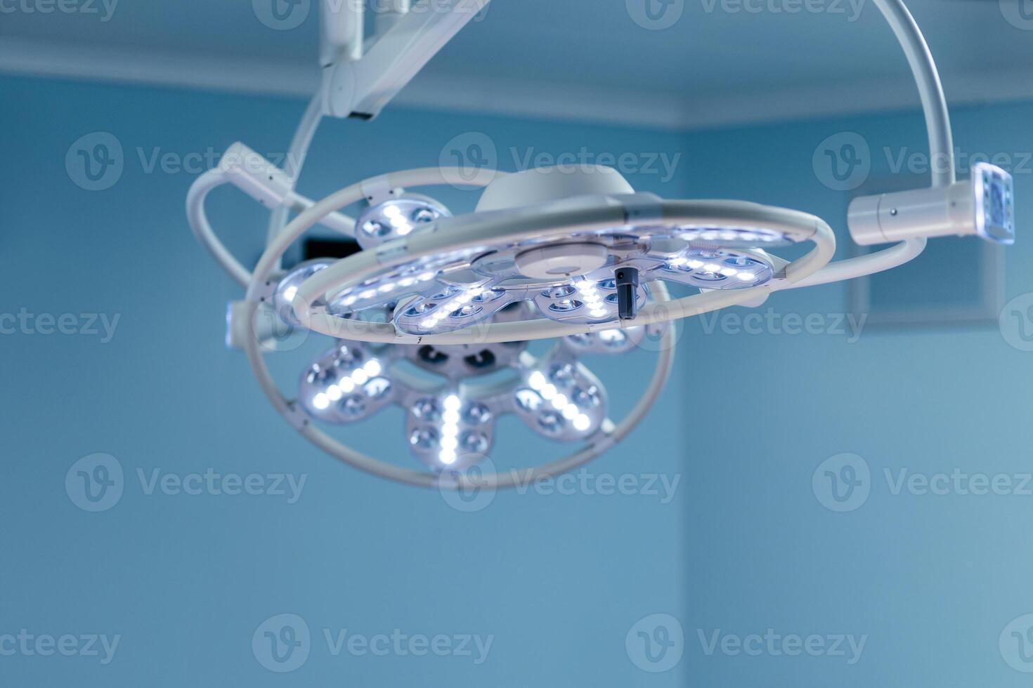 Empty operating room in a hospital with modern medical lamps. Close-up. Surgery operation. Medical blue background. Interior, technologies. Free copy space, banner photo