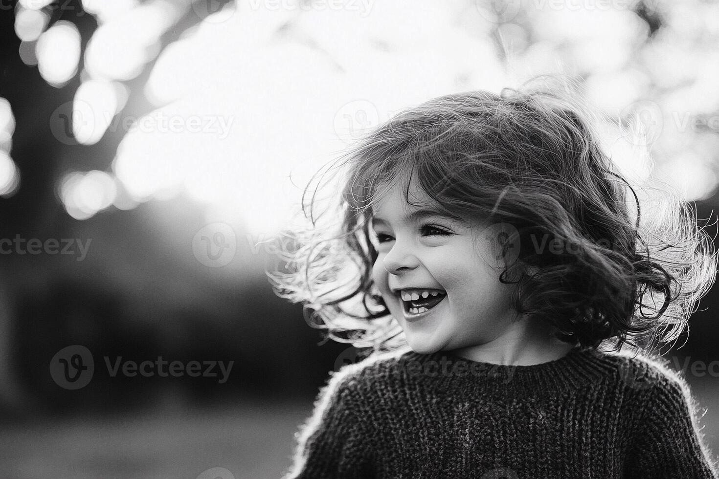 A little girl is laughing in the sun photo