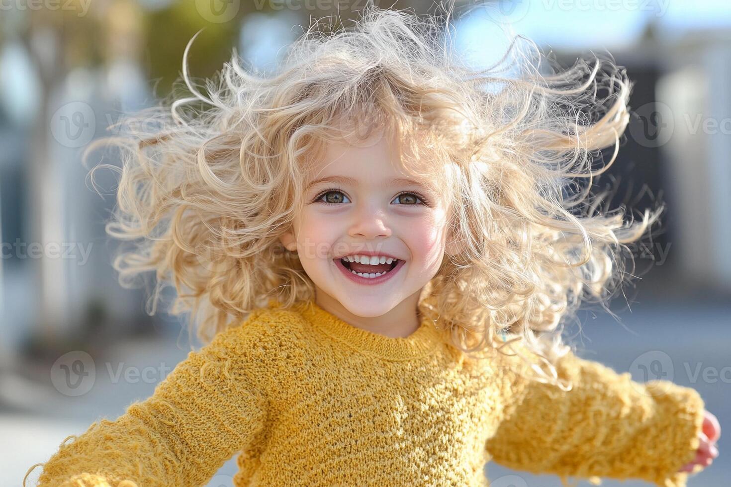 A little girl with curly hair is smiling photo