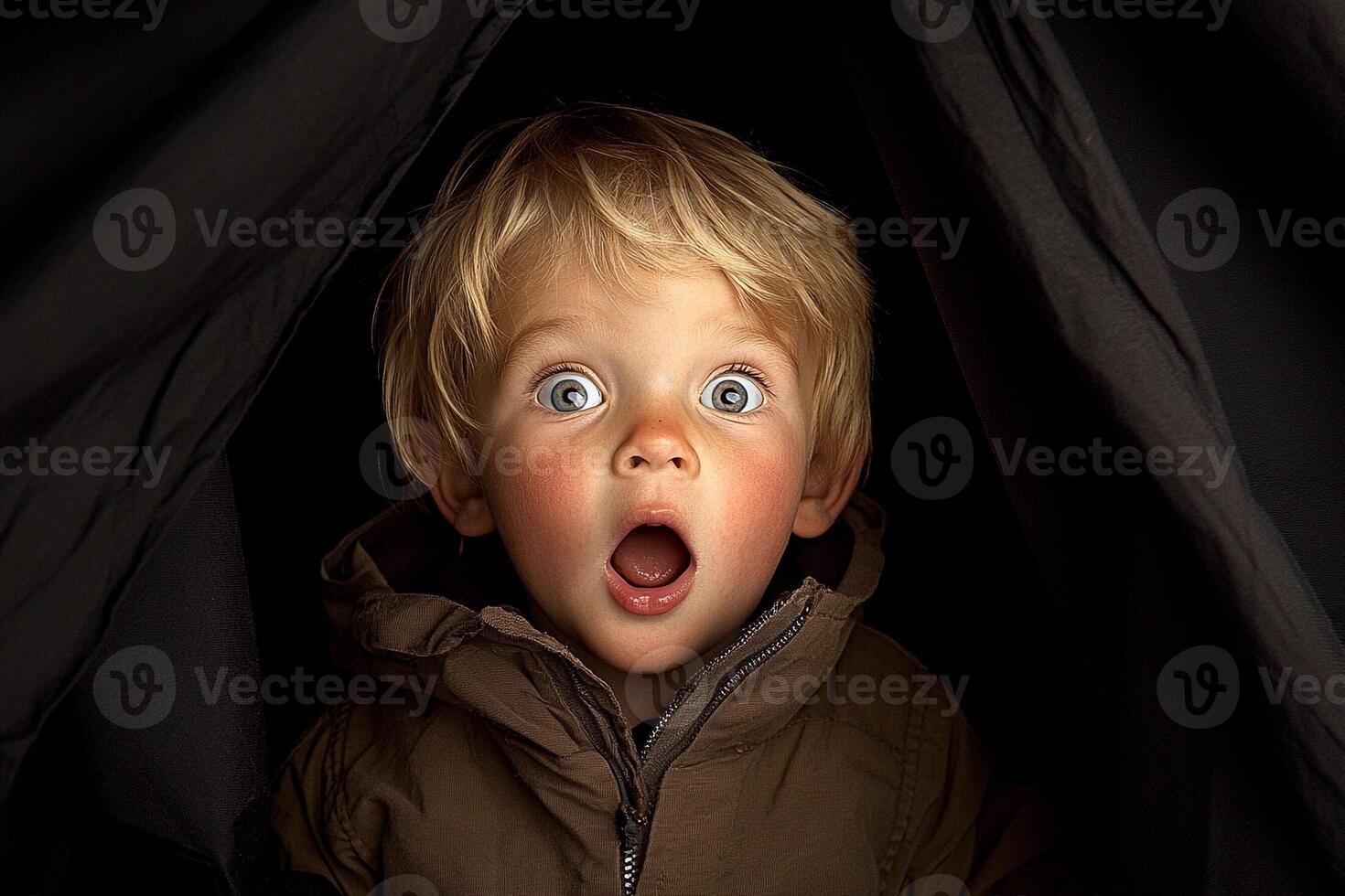 A young boy with a surprised look on his face photo