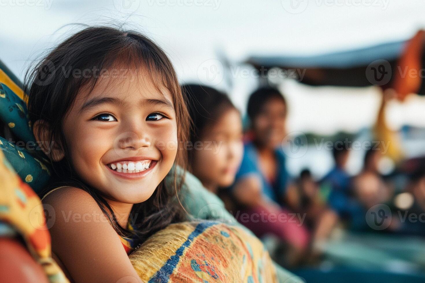 A little girl smiles while sitting on a boat photo