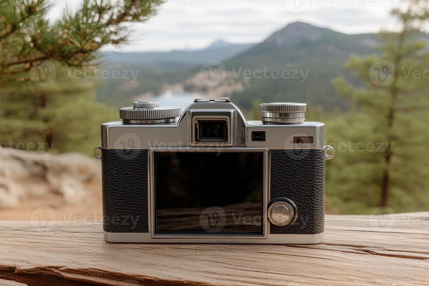 A camera sitting on a wooden table photo