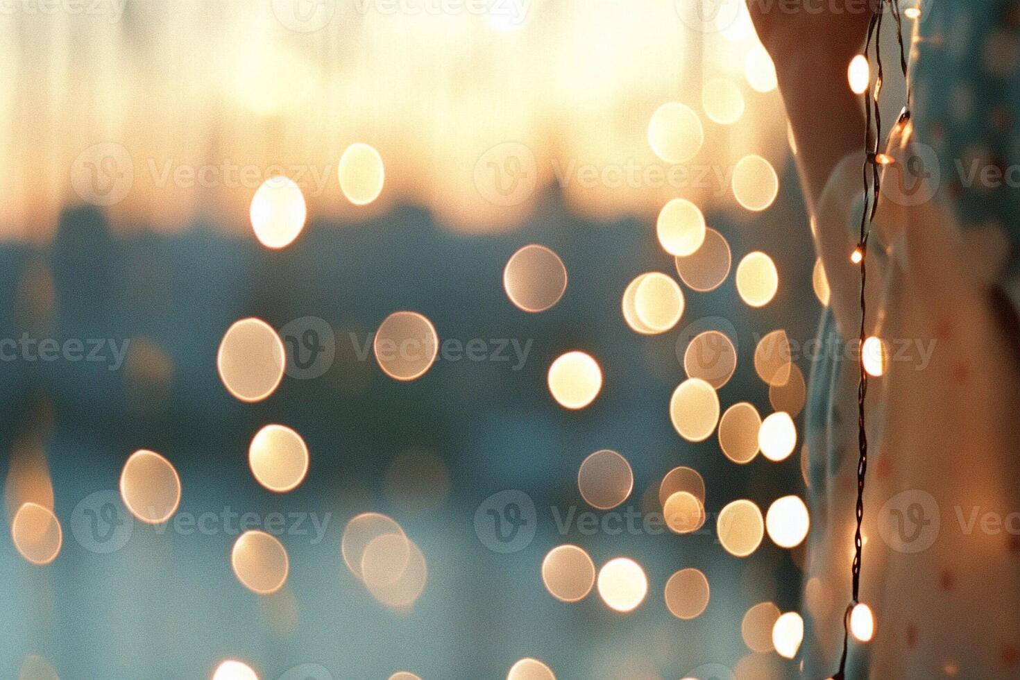 A person is standing in front of a window with lights photo