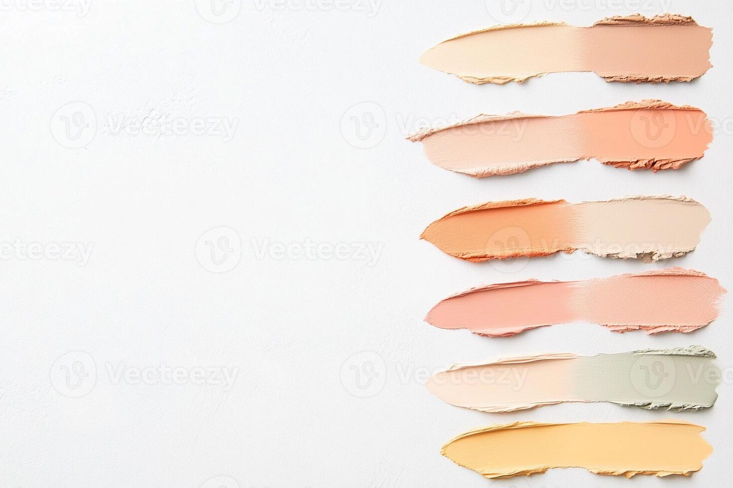 A group of different colored concealer sticks on a white surface photo