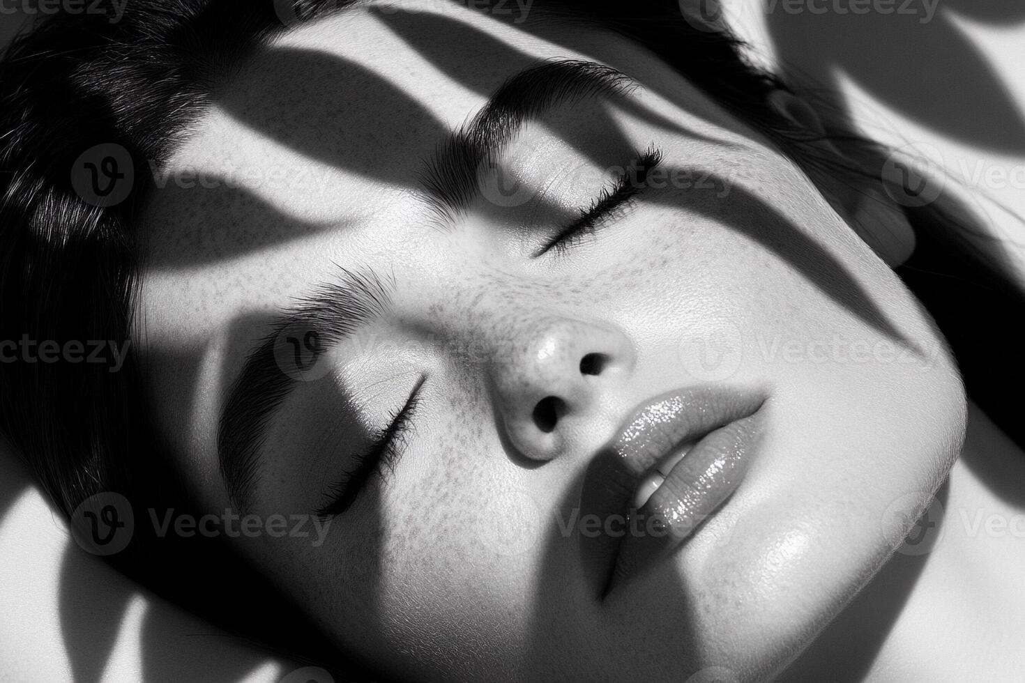 A woman with freckles and a black and white photo