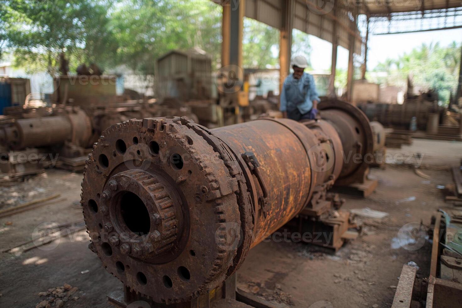 A man standing in front of a large metal machine photo