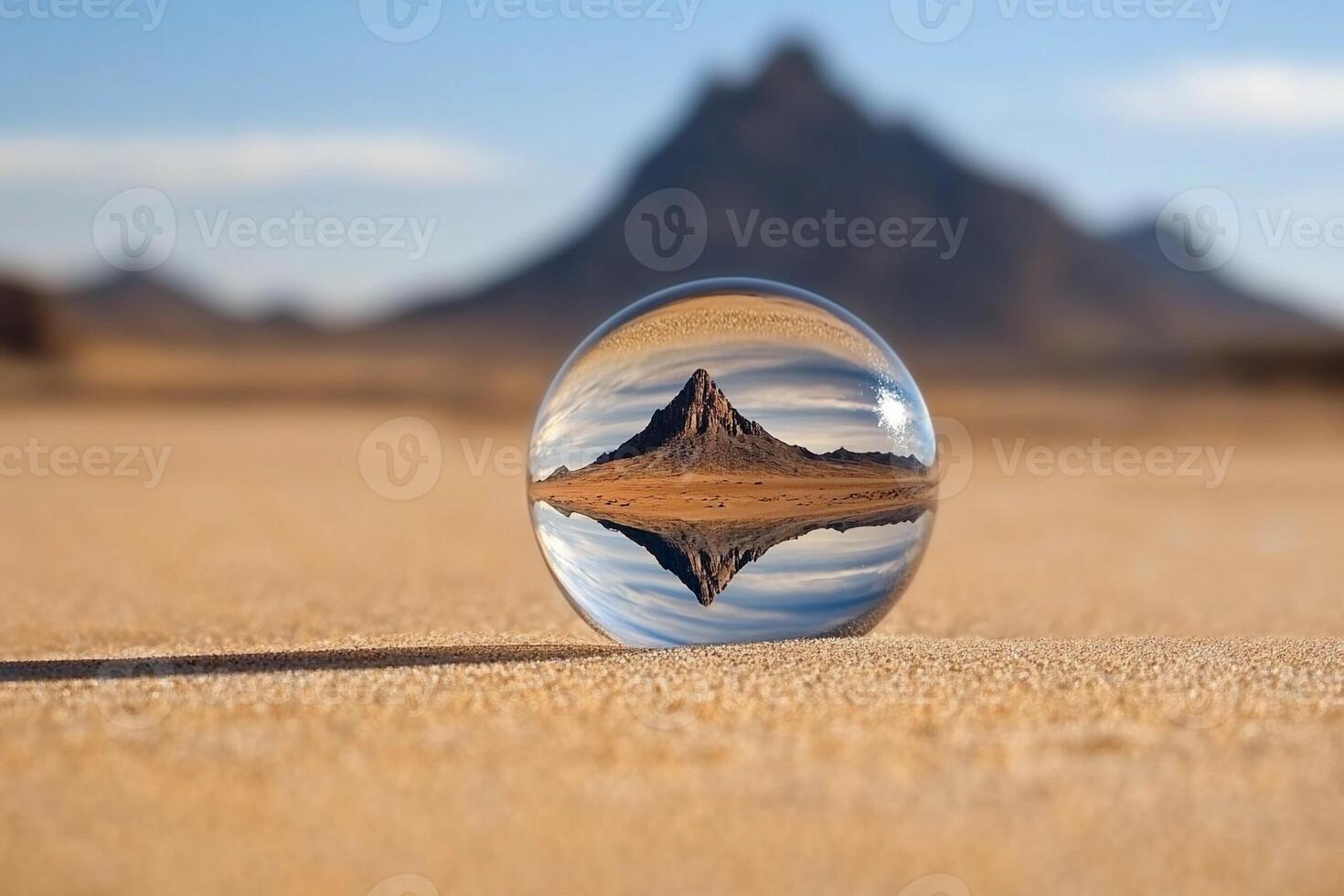 A glass ball with a mountain in the middle photo