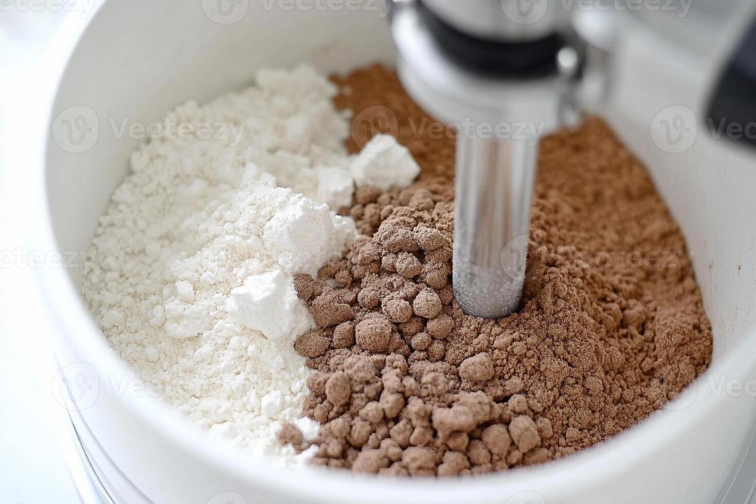 A mixer is mixing together ingredients in a bowl photo