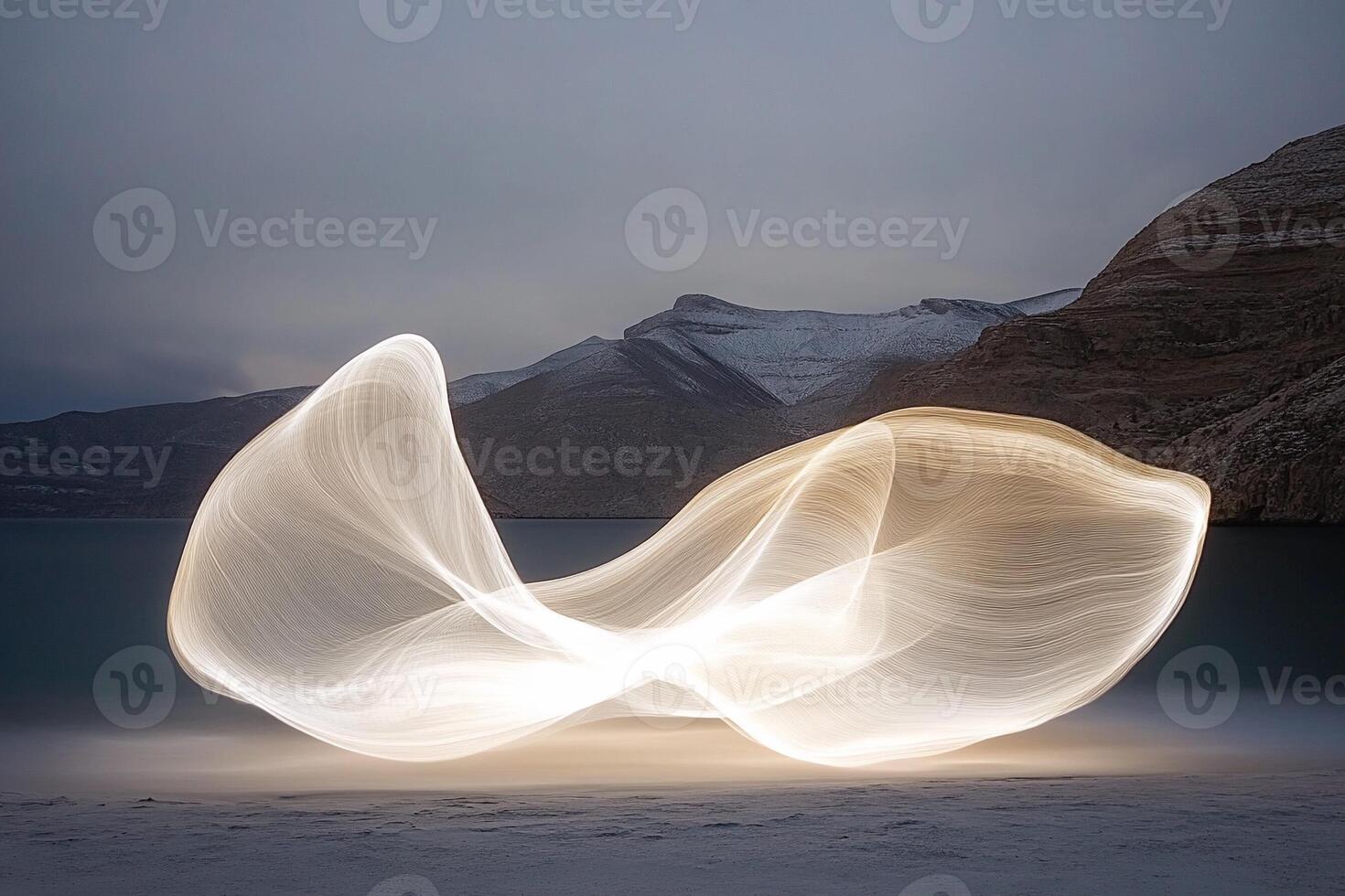 Light painting on a beach with mountains in the background photo