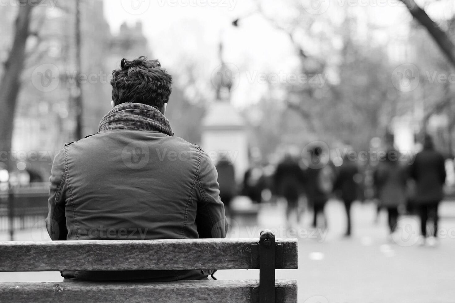 A man sitting on a bench in a park photo