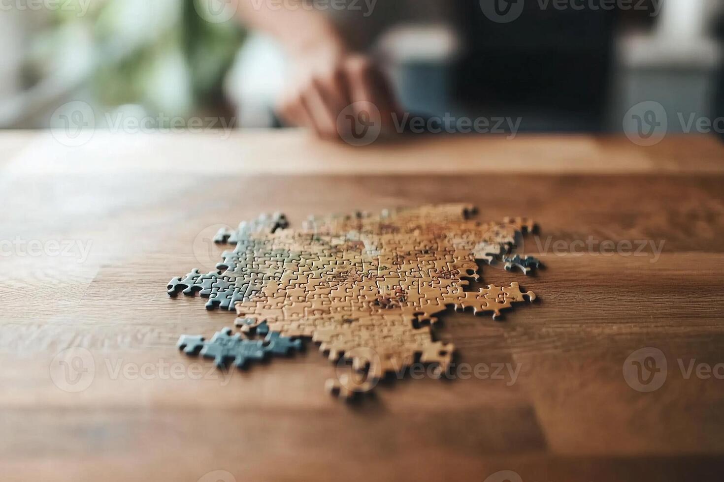 A person putting together a puzzle on a table photo