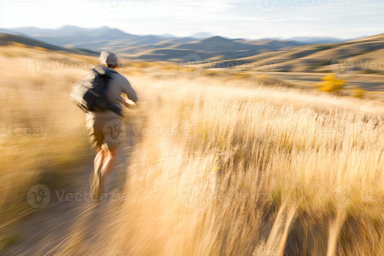 A man running through tall grass photo