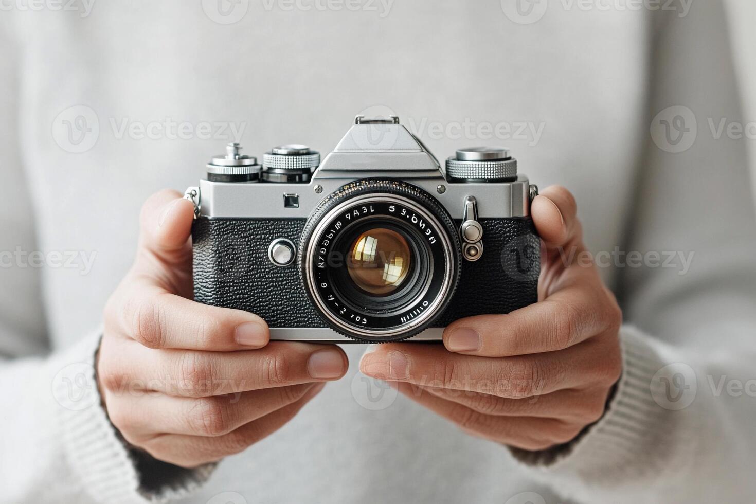 A person holding an old camera in their hands photo