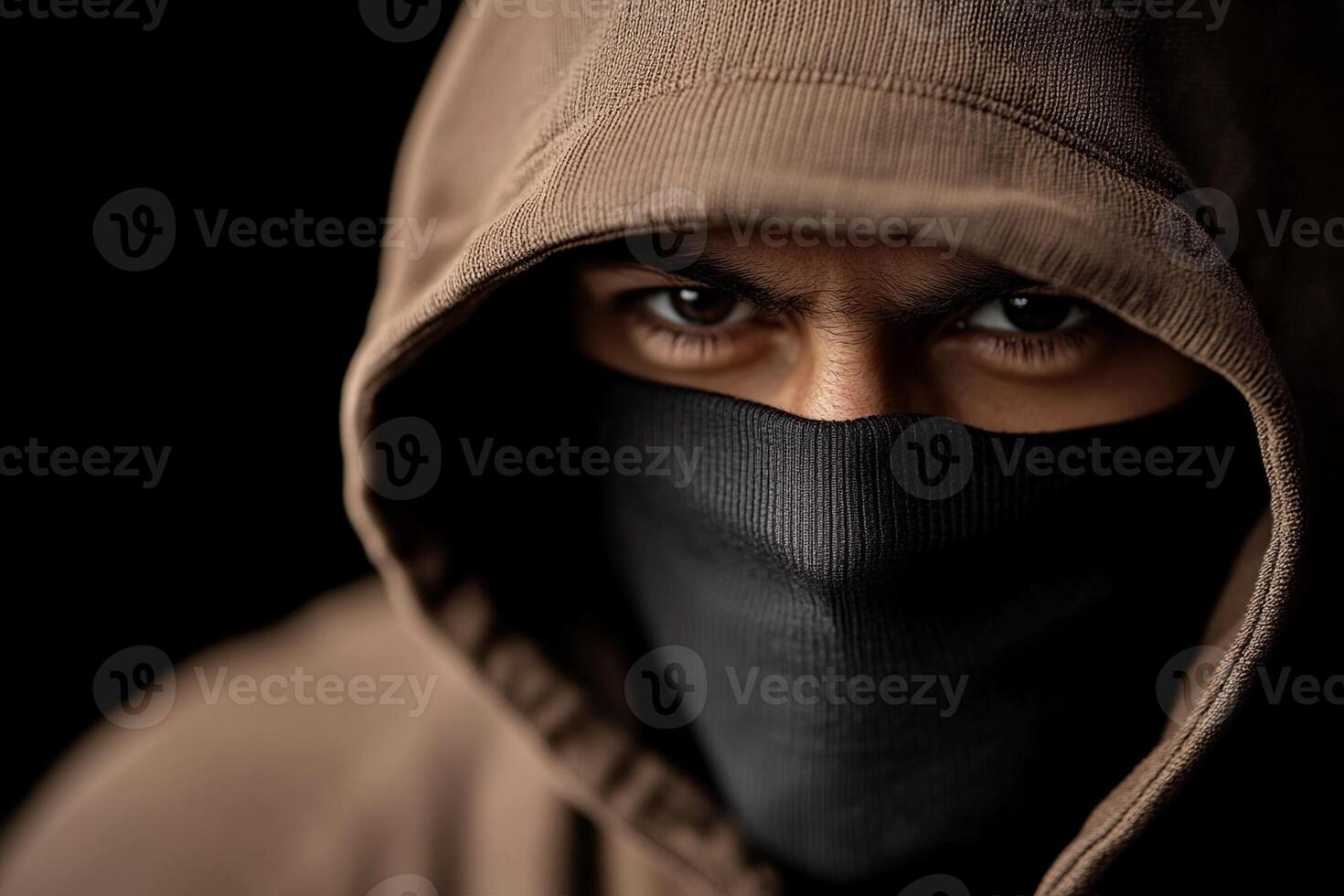 A man wearing a hoodie and a black face mask photo