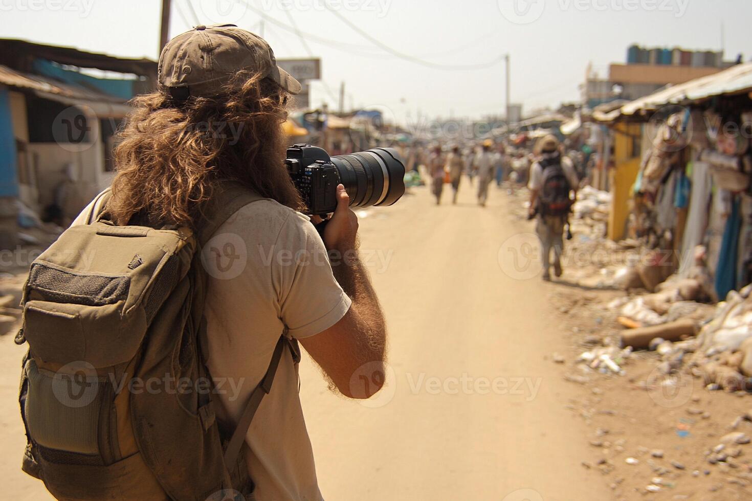 A man with a backpack is taking a picture of a street photo