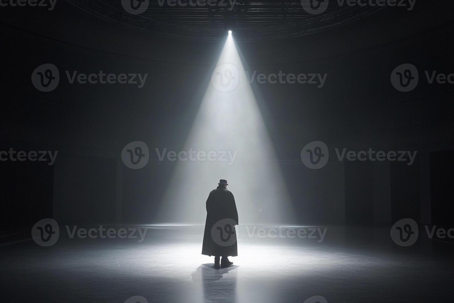 A man standing in the middle of a dark room photo