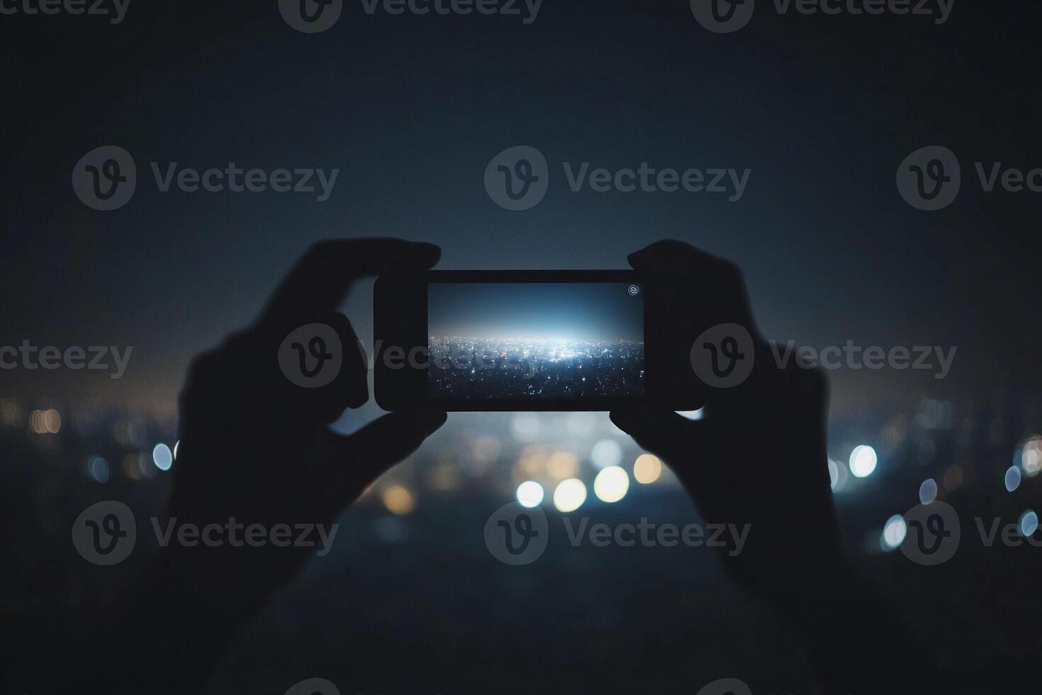 A person taking a photo with a smartphone at night