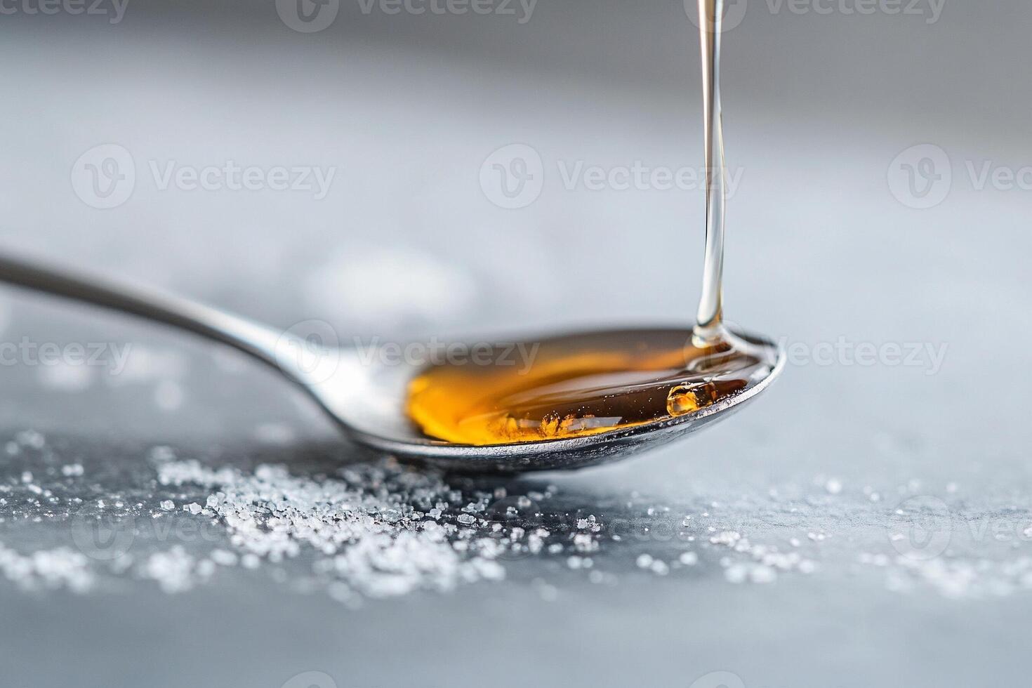 A spoon with sugar and syrup on it photo