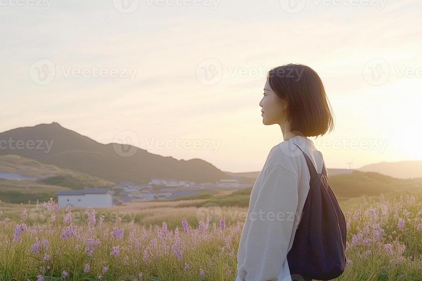 A woman standing in a field with purple flowers photo