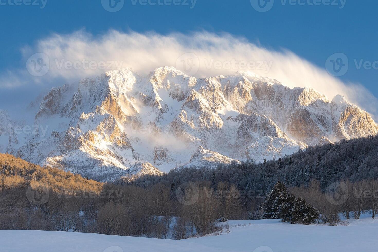 A snowy mountain covered in snow with a cloud in the sky photo