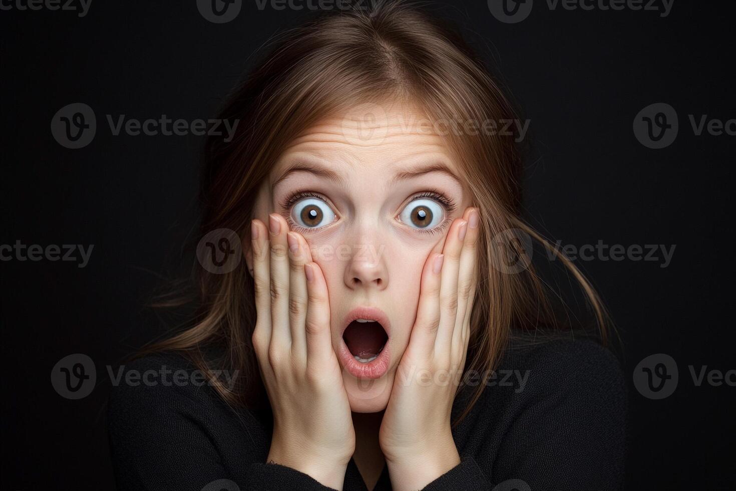 A woman with her mouth open and eyes wide photo