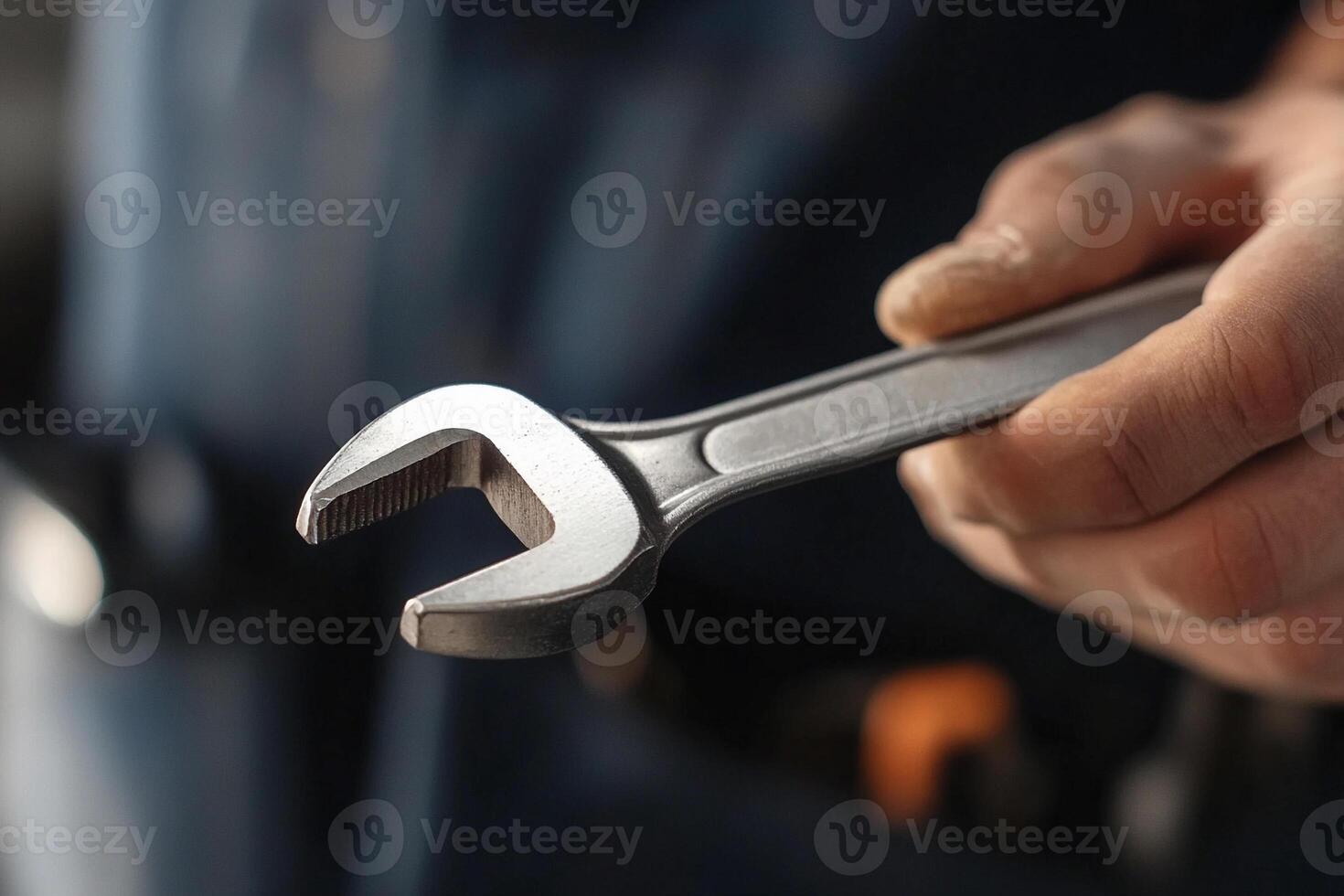 A person holding a wrench in their hand photo