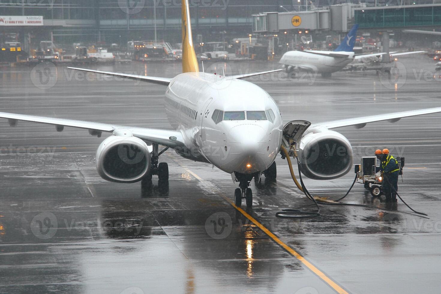A large airplane on a wet runway photo