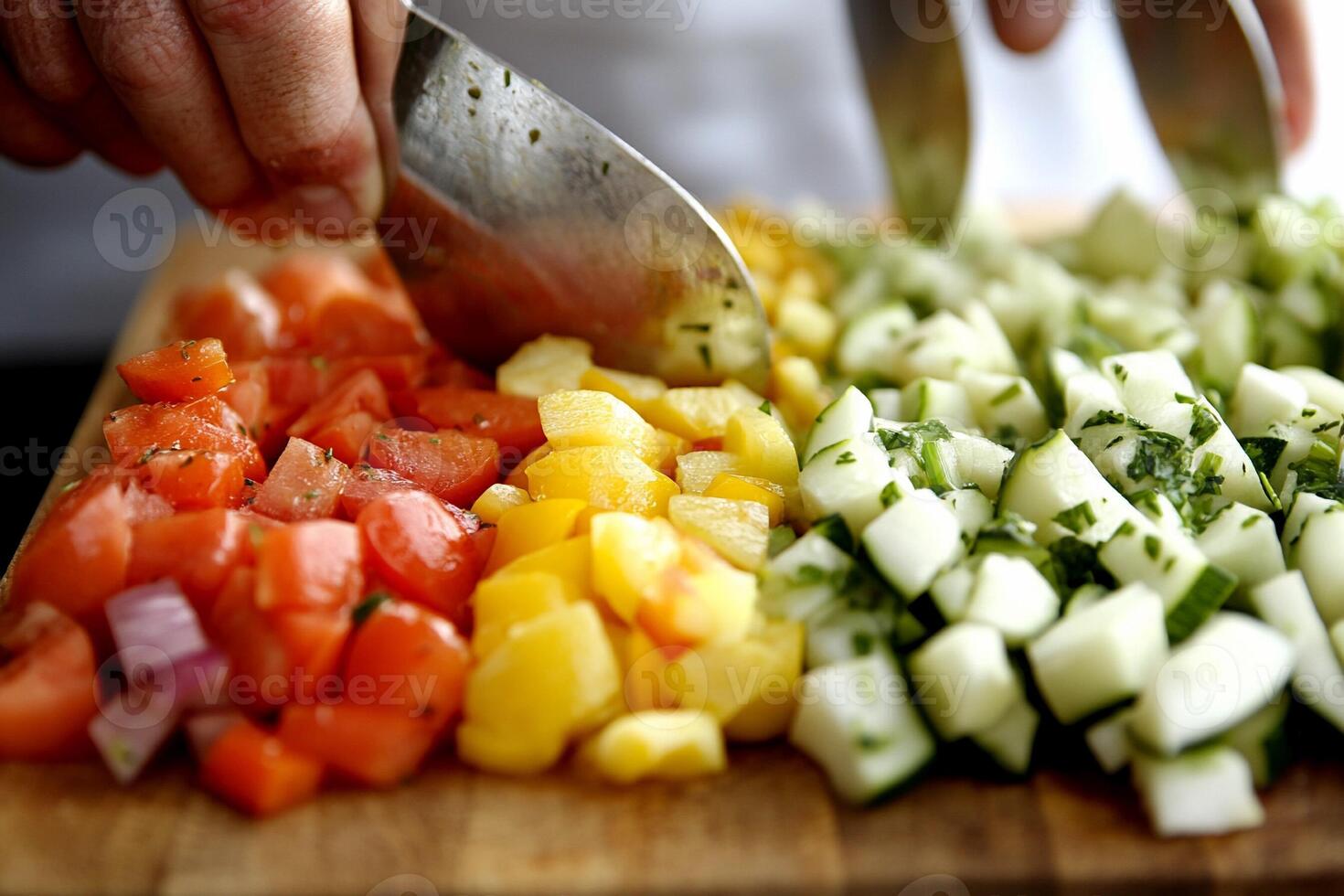 A person cutting up a bunch of different vegetables photo