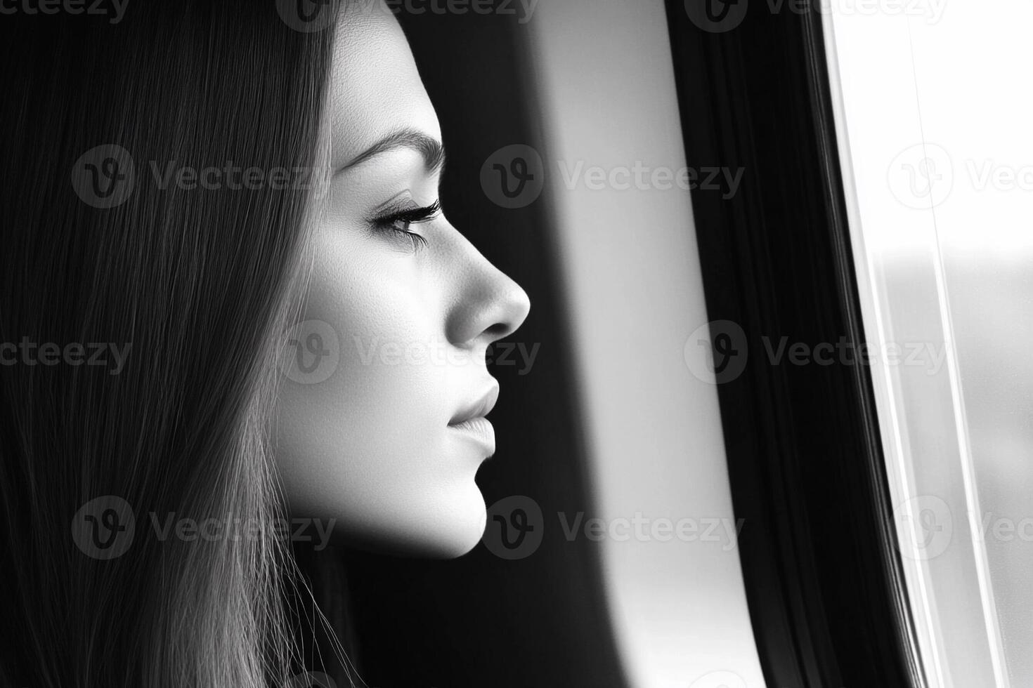 A woman looking out the window of a train photo