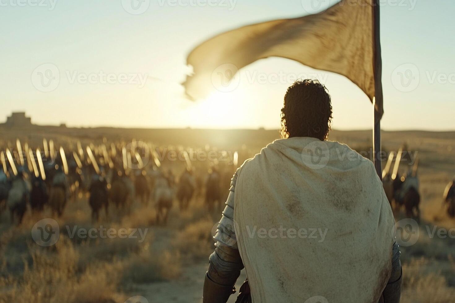 A man in a white robe is standing in the middle of a field photo