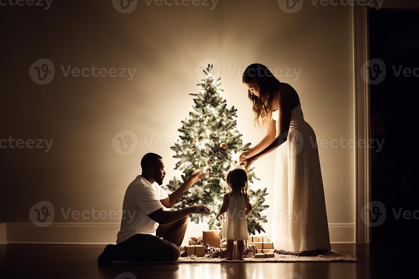 A family decorates a christmas tree in their home photo