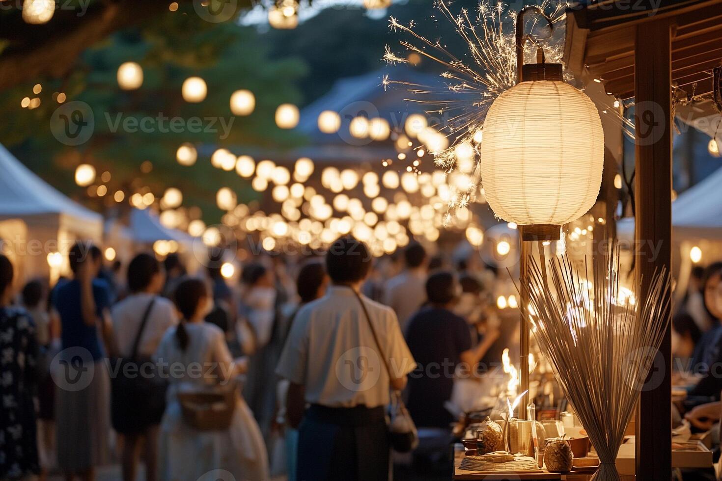 A crowd of people at an outdoor market with lanterns photo
