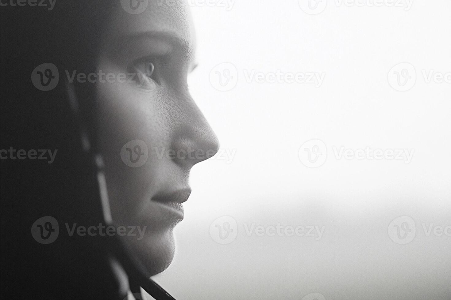 A woman with a hood on looks away from the camera photo