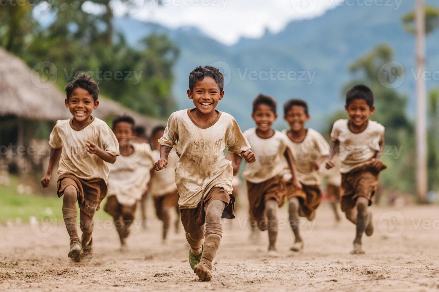A group of children running in the dirt photo
