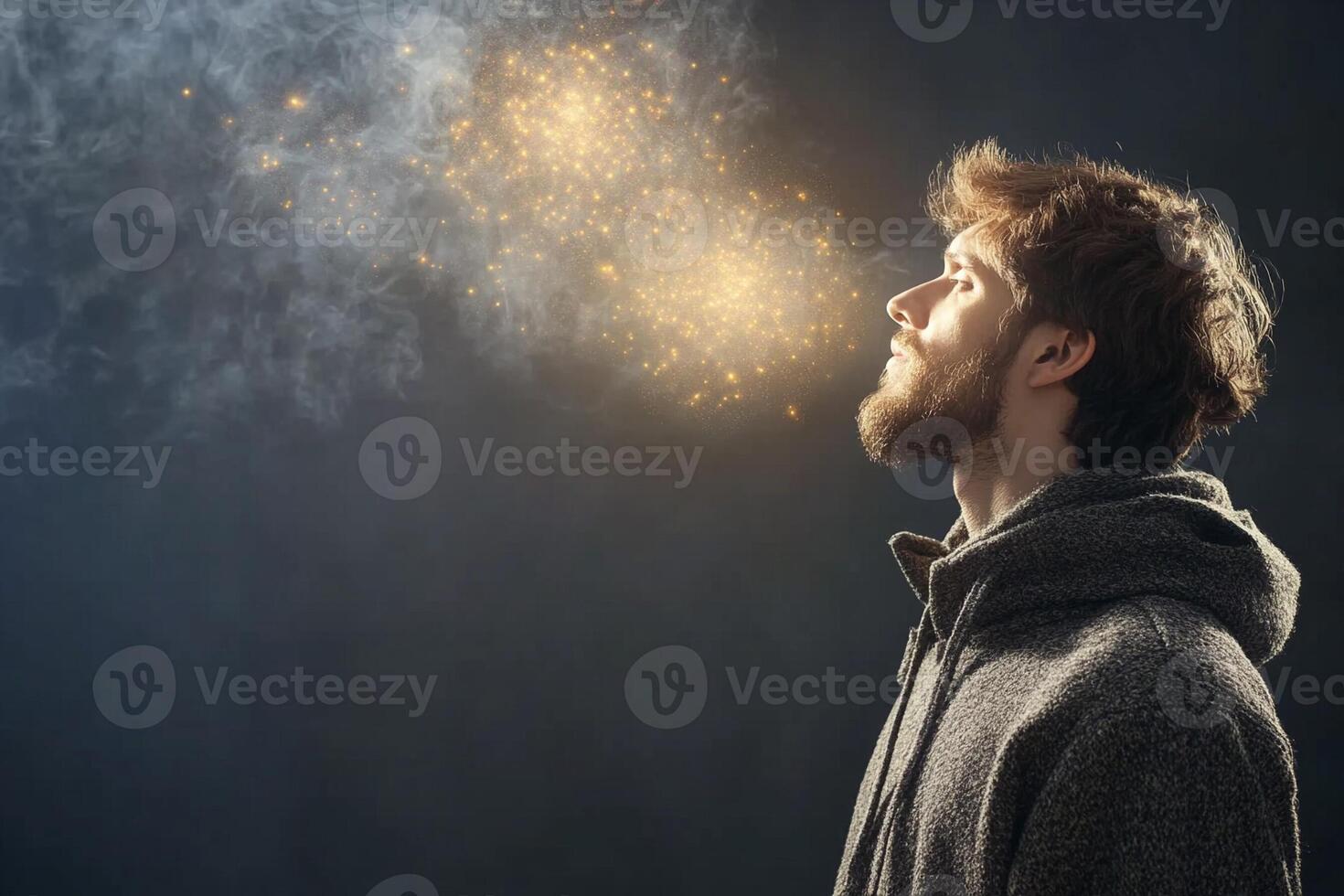 A man is looking up at a glowing light photo