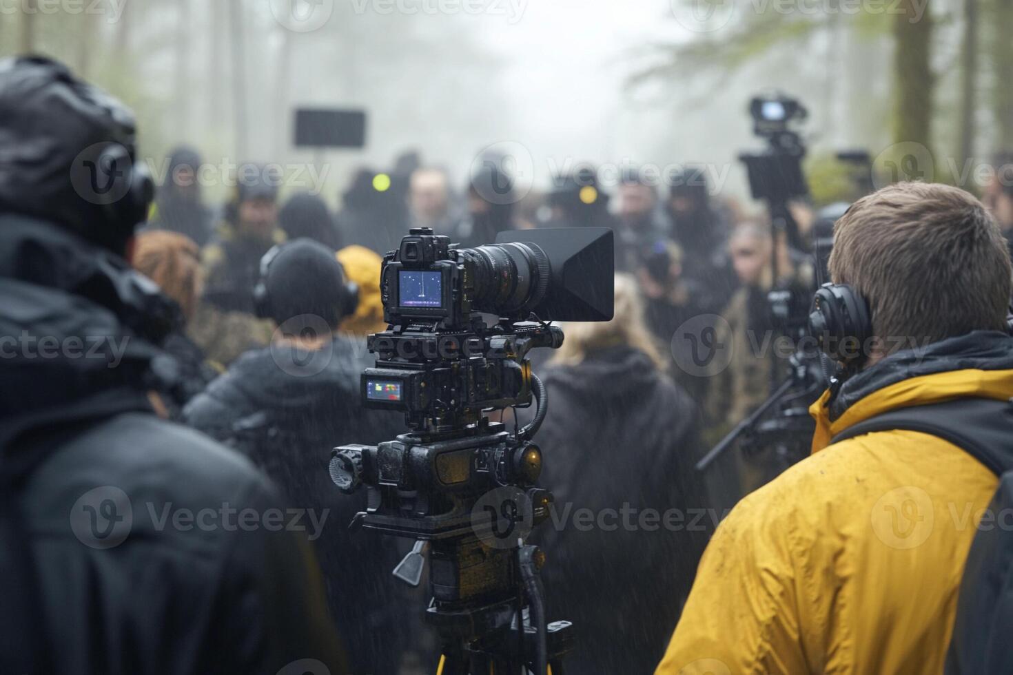 A group of people standing in the rain with cameras photo