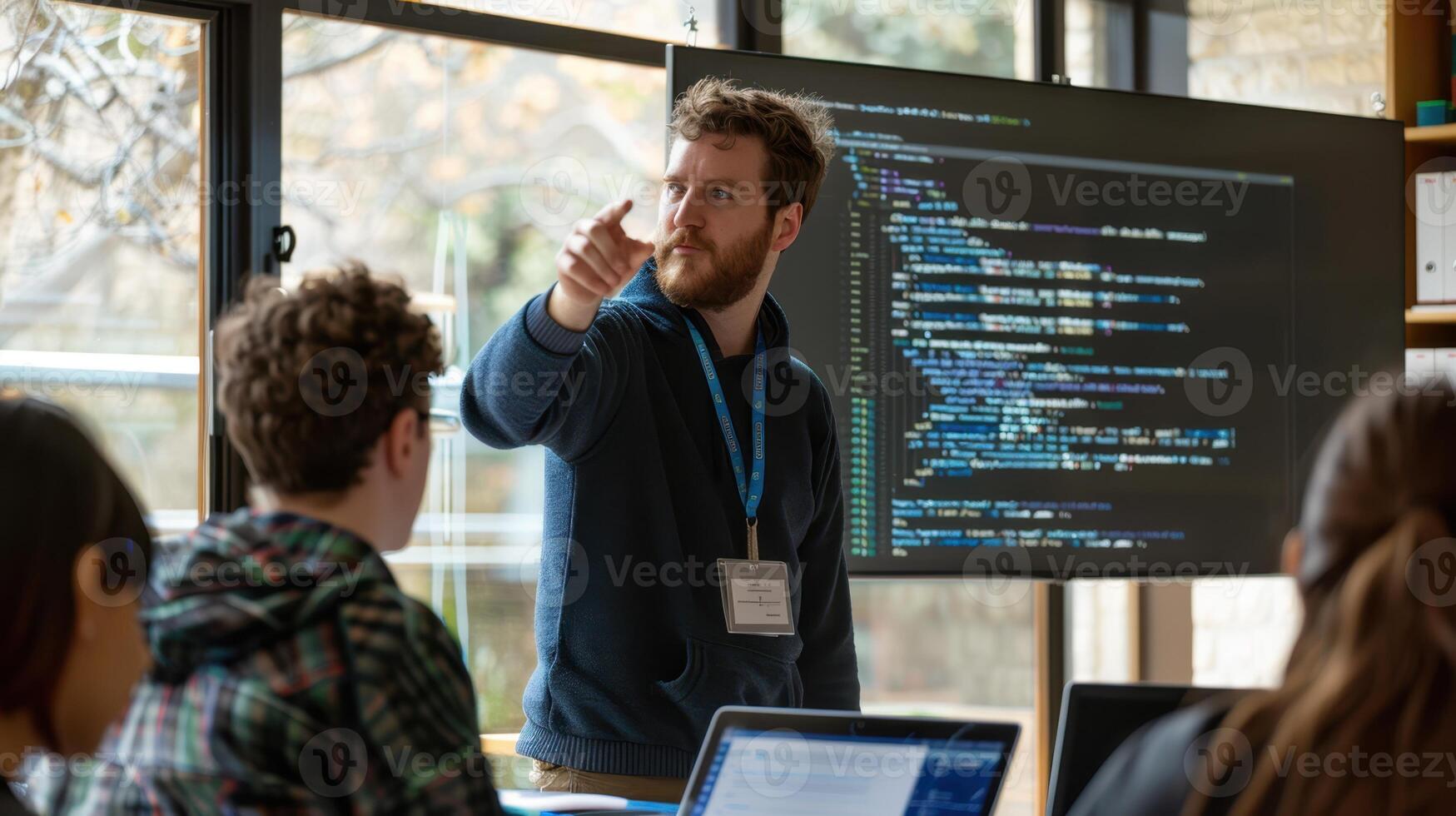 The instructor pointing at code photo