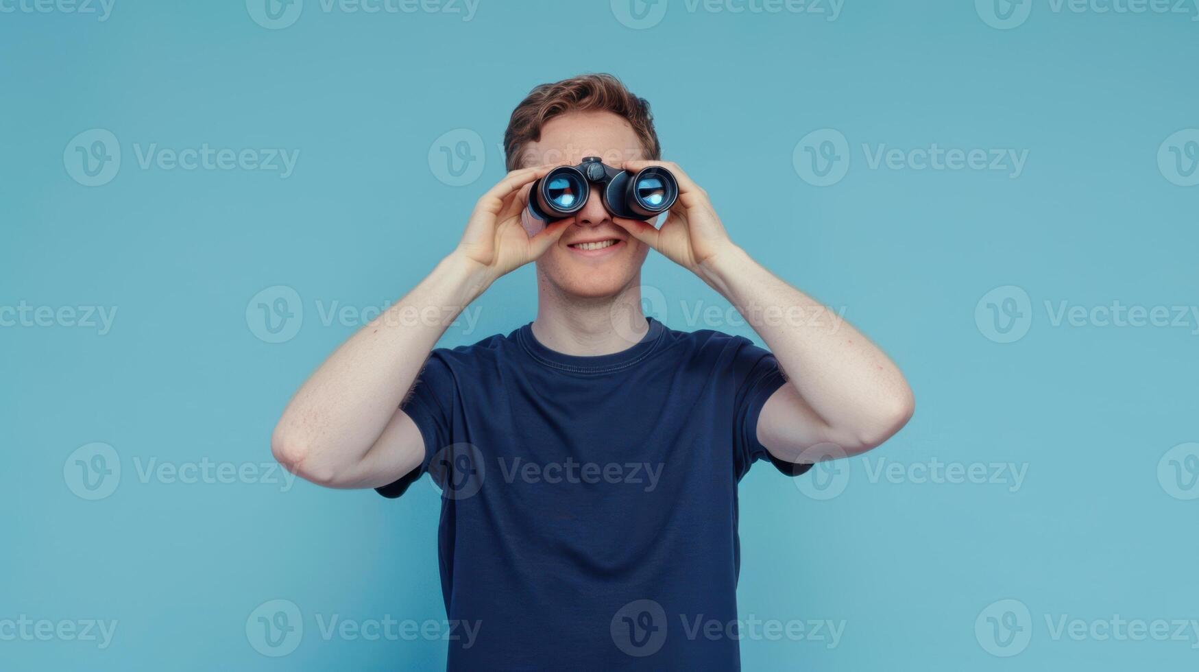 A man is looking through binoculars photo